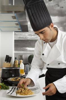 Chef finishing a rice noodles dish.