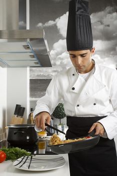 Chef serving rice noodles in plate.