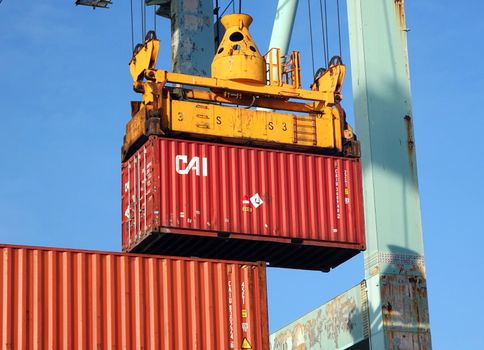 KAOHSIUNG, TAIWAN -- MAY 26, 2018: A shipping container is being loaded in the busy port of Kaohsiung, a major trading hub for Taiwan.
