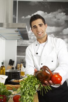 Chef showing proudly vegetables on his kitchen.