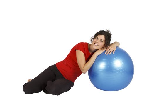Young woman sitting with a blue yoga ball.
