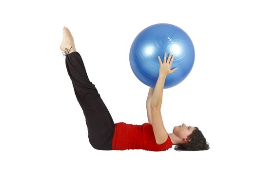 Young woman raising legs while she holds a blue yoga ball.