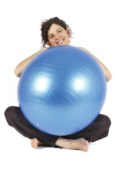 Young woman sitting with a blue yoga ball.