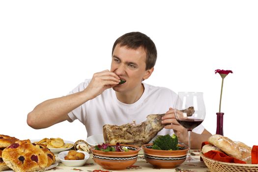 Young man eating a broccoli. Isolated of white background.