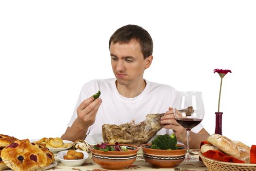 Young man look at a broccoli with disgusting face. Isolated of white background.