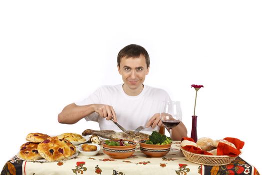 Young man about to eat a leg of lamb. Isolated of white background.