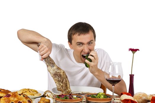 Bad mannered young man eating broccoli. Isolated of white background.