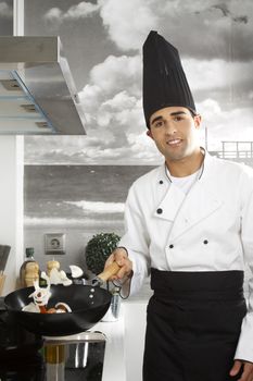 Chef juggling onions and red peppers.