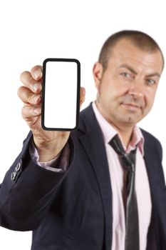 Businesman out of focus at background showing a mobile phone with white display. Isolated on white background.