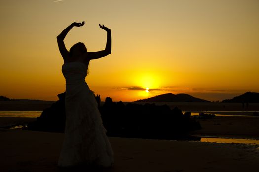 Bride dancing at sunset. Low light