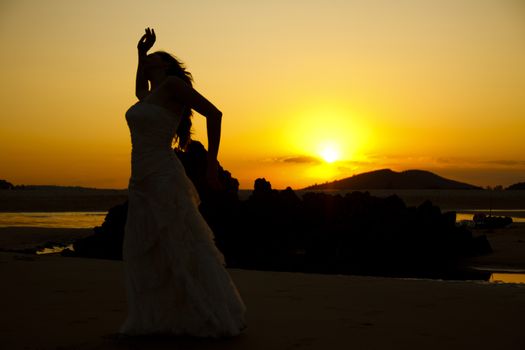 Bride dancing at sunset. Low light