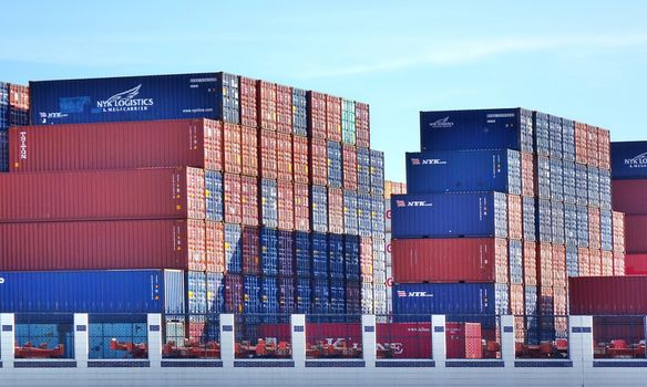 KAOHSIUNG, TAIWAN -- MAY 26, 2018: Large shipping container are stacked at the Kaohsiung container port in preparation for transport.
