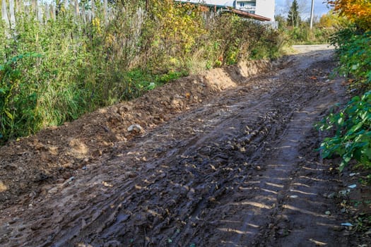 pavement in a provincial Russian city in poor condition, puddles and dirt