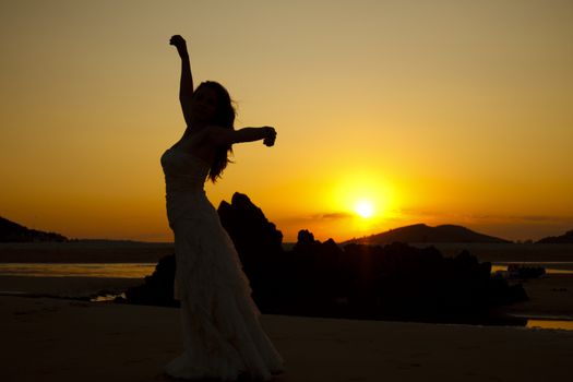 Bride dancing at sunset. Low light