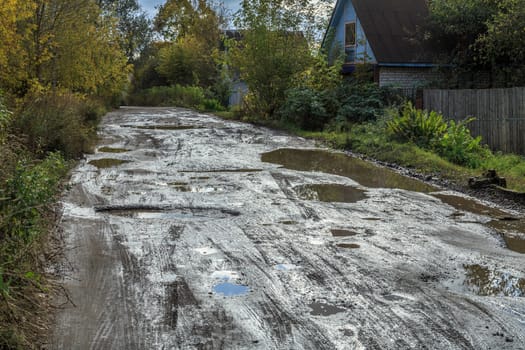 roadway in a provincial Russian city in poor condition, pits and dirt