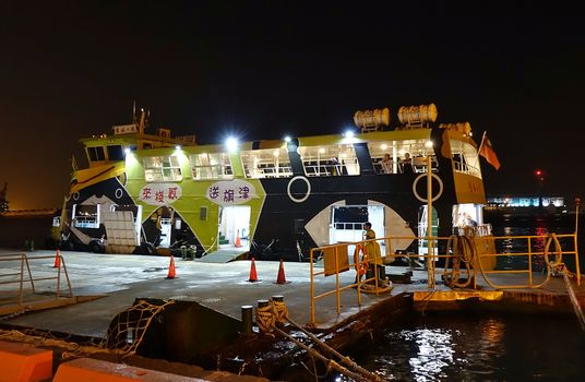 KAOHSIUNG, TAIWAN -- DECEMBER 22, 2018: A cross-harbor ferry boat is docked at the pier waiting for travelers to board.
