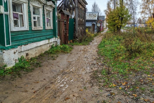 pavement in a provincial Russian city in poor condition, puddles and dirt