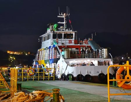 KAOHSIUNG, TAIWAN -- DECEMBER 22, 2018: A cross-harbor ferry boat is docked at the pier waiting for travelers to board.