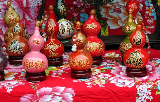 KAOHSIUNG, TAIWAN -- FEBRUARY 16, 2018: An outdoor vendor sells small dried gourds that are painted and varnished and decorated with Buddhist scriptures.
