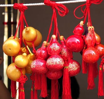 KAOHSIUNG, TAIWAN -- FEBRUARY 19, 2015: An outdoor vendor sells small dried gourds that are painted and varnished and decorated with Buddhist scriptures.
