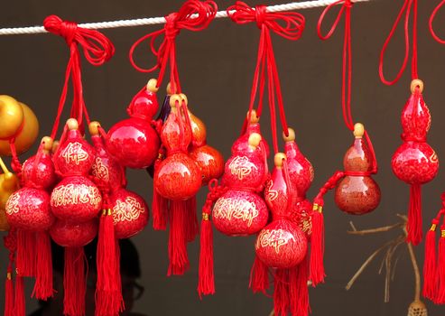 KAOHSIUNG, TAIWAN -- FEBRUARY 19, 2015: An outdoor vendor sells small dried gourds that are painted and decorated with Buddhist scriptures.