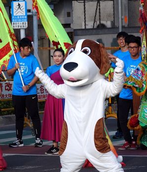 KAOHSIUNG, TAIWAN -- MARCH 2, 2018: A street performer in a dog costume poses during the 2018 Lantern Festival to welcome the Year of the Dog.