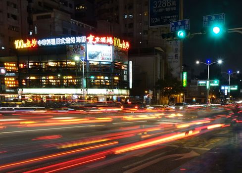 KAOHSIUNG, TAIWAN -- DECEMBER 1, 2018: Busy traffic during evening rush hour in downtown Kaohsiung. The image features motion blur.