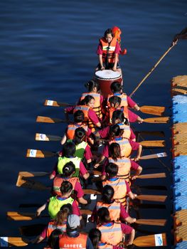 KAOHSIUNG, TAIWAN - JUNE 6: A team of female rowers waits at the starting line for the dragon boat race on the Love River on June 6, 2011 in Kaohsiung