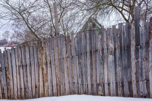 old fence around the garden of nailing boards