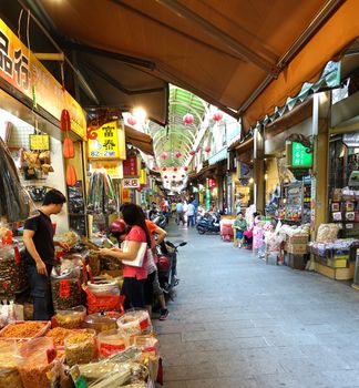 KAOHSIUNG, TAIWAN -- MAY 31, 2014: Shoppers buy goods at the famous Zongjie dry goods market which sells grains, nuts, dried meat, fish, seafood, herbs and fruits.