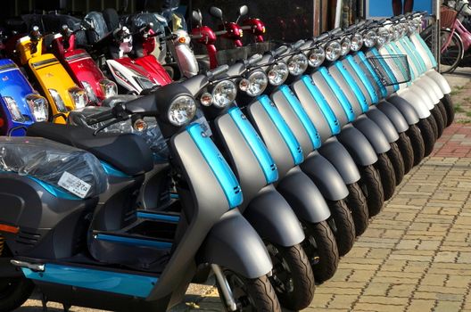 KAOHSIUNG, TAIWAN -- MAY 12, 2018: To phase out gasoline scooters the switch to electric scooters is encouraged. Here is a line up of brand new electric scooters for sale.
