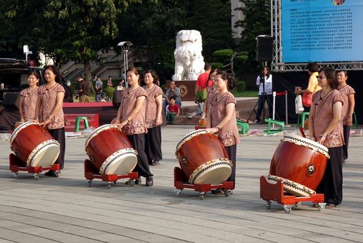 KAOHSIUNG, TAIWAN -- NOVEMBER 8, 2014: A group of female percussionists gets ready for an outdoor performance