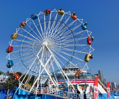 KAOHSIUNG, TAIWAN -- JANUARY 11, 2020: A ferris wheel with colorful cabins at a local fun fair