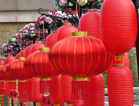 KAOHSIUNG, TAIWAN -- JANUARY 25, 2020: To celebrate the Chinese Year the Fo Guang Shan Buddhist complex is decorated with red lanterns and flowers. The Chinese characters mean "Peace".