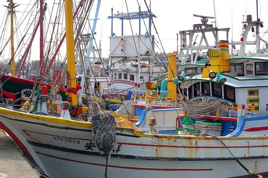 KAOHSIUNG, TAIWAN -- MARCH 14, 2014: Traditional Chinese wooden fishing boats seek shelter at Zi Guan Port.