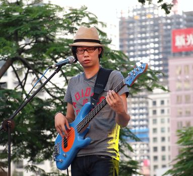 KAOHSIUNG, TAIWAN - JUNE 23: Local pop group Fleabags entertains visitors to the 2012 Dragon Boat Festival along the Love River on June 23, 2012 in Kaohsiung 