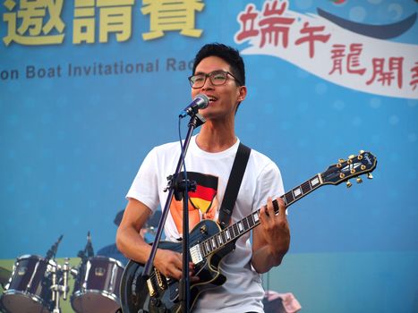 KAOHSIUNG, TAIWAN - JUNE 23: Local pop group Fleabags entertains visitors to the 2012 Dragon Boat Festival along the Love River on June 23, 2012 in Kaohsiung