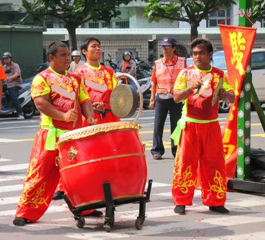 -- using various percussion instruments at a ceremony

