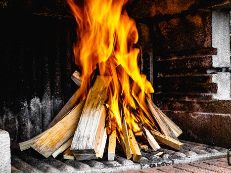 Preparation of a BBQ - wood piled up - fire reaching maximum heat