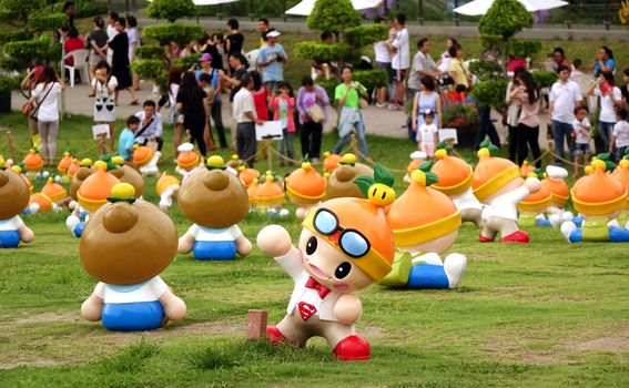 KAOHSIUNG, TAIWAN -- JUNE 28, 2014: These cute fruit wizards have been set up in a public park by the agricultural bureau to promote the sale of local farm products.