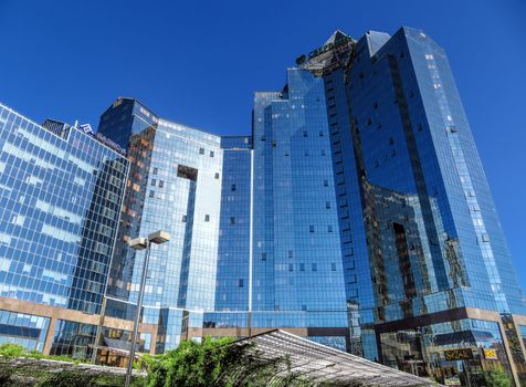 ALMATY, KAZAKHSTAN - MAY 14, 2017: Business Center Nurly Tau in Almaty, Kazakhstan. Made in the style of Hi-Tech, repeating silhouettes of mountains Zailisky Alatau. Construction company - Basis A.

Almaty, Kazakhstan - May 14, 2017: Business Center Nurly Tau in Almaty, Kazakhstan. Made in the style of Hi-Tech, repeating silhouettes of mountains Zailisky Alatau. Construction company - Basis A.
