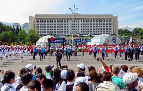 ALMATY, KAZAKHSTAN - JUNE 1, 2017: Solemn parade of children's and youth musical orchestras and ensembles on the Republic Square. More than 5,000 schoolchildren of the megapolis took part in the parade.

Almaty, Kazakhstan - June 1, 2017: Solemn parade of children's and youth musical orchestras and ensembles on the Republic Square. More than 5,000 schoolchildren of the megapolis took part in the parade.