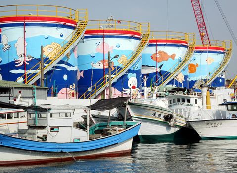 KAOHSIUNG, TAIWAN -- OCTOBER 11, 2014: Storage tanks with colorful illustrations can be seen at a small fishing port on Cijin island.