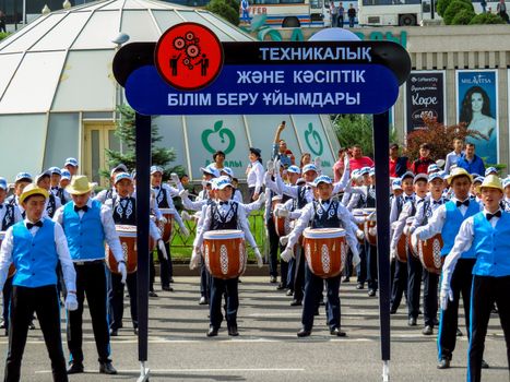 ALMATY, KAZAKHSTAN - JUNE 1, 2017: Solemn parade of children's and youth musical orchestras and ensembles on the Republic Square. More than 5,000 schoolchildren of the megapolis took part in the parade.

Almaty, Kazakhstan - June 1, 2017: Solemn parade of children's and youth musical orchestras and ensembles on the Republic Square. More than 5,000 schoolchildren of the megapolis took part in the parade.