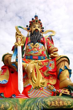 KAOHSIUNG, TAIWAN -- MAY 25, 2014: This giant statue of a Taoist god is believed to guard the Lotus Lake in Kaohsiung, Taiwan.