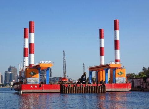 KAOHSIUNG, TAIWAN -- FEBRUARY 7, 2019: A floating dock construction rig is at work in Kaohsiung Harbor at a bridge building project.
