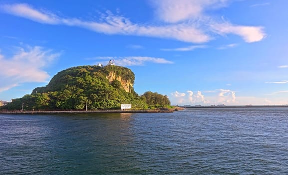 KAOHSIUNG, TAIWAN -- JULY 4, 2016: A view of the historic lighthouse on the island of Chijin marking the entrance to Kaohsiung Harbor.