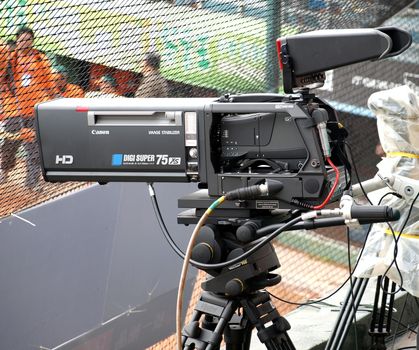 PINGTUNG, TAIWAN -- APRIL 8, 2012: A professional high definition broadcast television camera is used to record a game of the Taiwan professional baseball league.