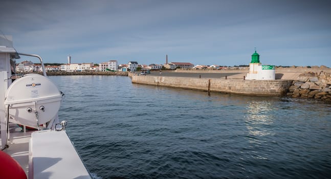 Ile d Yeu, France - September 16, 2018: View of the bridge of a ferry that enters the harbor of the island of Yeu where travelers are sitting to admire the show on a summer day