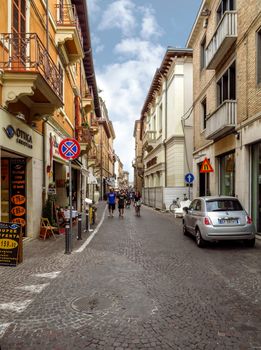 Rimini, Italy - June 14, 2017: Unrecognizable people are walking down the street in the old center of the Rimini